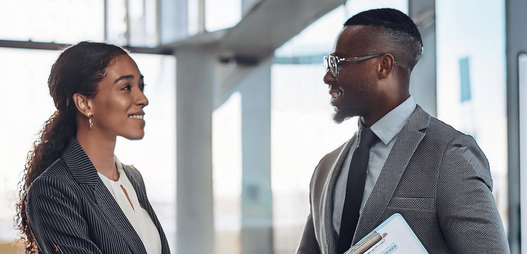 A man and woman shaking hands over a completed deal.